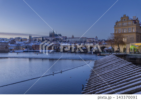 Prague Castle and Charles Bridge in winter evening 143370091