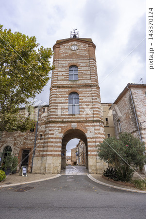 Clock tower entrance welcoming visitors in Auvillar, France Clock tower entrance welcoming visitors in Auvillar, France 143370124