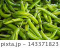 Close up photo of green hot chili peppers on the market 143371823