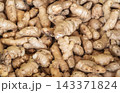 Fresh raw ginger root with sliced pieces showing yellow fibrous texture Stock Photo 143371824