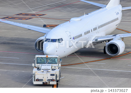 出発準備を進める旅客機とトーイングカー 出発準備を進める旅客機とトーイングカー 143373027