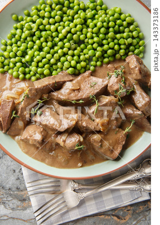 Saure Leber a traditional German beef liver dish from Baden closeup on the plate on the table. Vertical top view 143373186