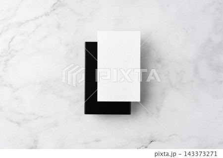 Blank white business cards and close black aluminum card holder on white marble background, top view flat lay with copy space Blank white business cards and close black aluminum card holder on white marble background, top view flat lay with copy space 143373271