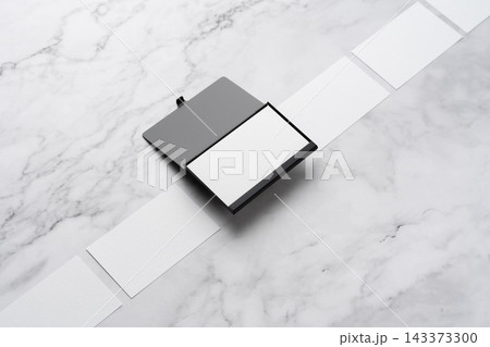 Blank white business cards and open black aluminum card holder on white marble background, high angle view with copy space Blank white business cards and open black aluminum card holder on white marble background, high angle view with copy space 143373300