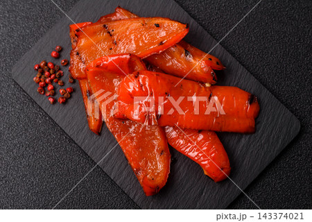 Grilled red bell pepper slices seasoned with salt and spices. Grilled sweet pepper 143374021
