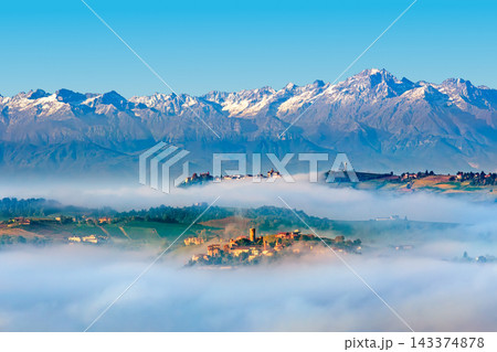 Panoramic view of Langhe hills shrouded in morning mist, Piedmont, Italy. Panoramic view of Langhe hills shrouded in morning mist, Piedmont, Italy. 143374878
