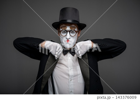 Male mime artist performing classic invisible wall illusion 143376009