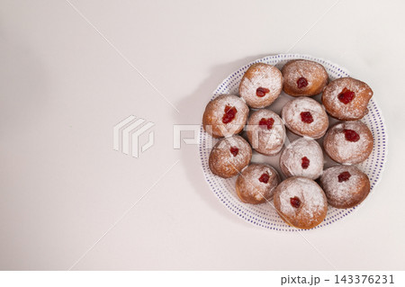 Overhead view of homemade Hanukkah sufganiyot with jam 143376231