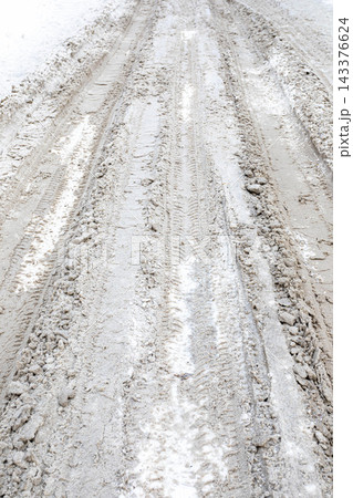 Snow covered road with tire tracks in winter outdoor landscape Snow covered road with tire tracks in winter outdoor landscape 143376624
