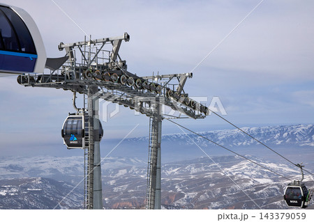 Amirsoy Ski Resort cable car terminal above snow-covered mountains. Gondola lift infrastructure across Central Asian alpine terrain. Winter travel and mountain transport. Uzbekistan - 5 FEB 2025 Amirsoy Ski Resort cable car terminal above snow-covered mountains. Gondola lift infrastructure across Central Asian alpine terrain. Winter travel and mountain transport. Uzbekistan - 5 FEB 2025 143379059