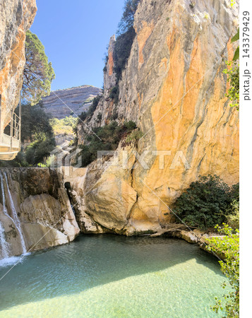 Turquoise pool below a small weir in the Rio Vero canyon with the walkway above 143379429