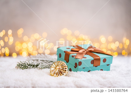 Teal Polka Dot Gift Box with Brown Ribbon on Snow Teal Polka Dot Gift Box with Brown Ribbon on Snow 143380764