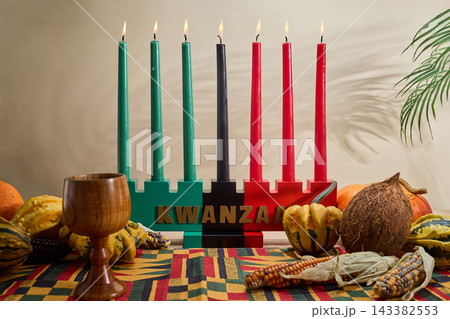 Kwanzaa kinara with seven lit mishumaa saba candles 143382553