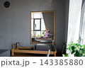 Woman doing mermaid exercise in a sunlite, modern pilates studio, embodying calm, focus, and strength. 143385880