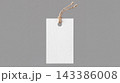 Blank white rectangular price tag with brown string on a grey background shopping merchandise accessory business commerce branding template rectangle isolated background advertising 143386008