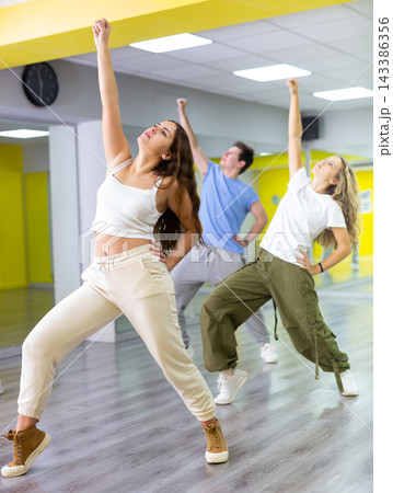 Young girl training breakdance Toprock moves in dance hall Young girl training breakdance Toprock moves in dance hall 143386356
