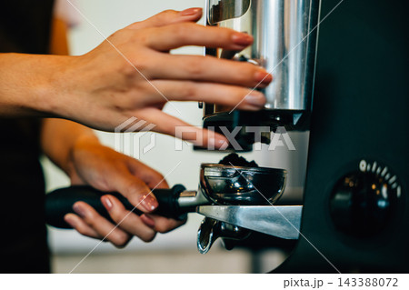 Coffee machine prepares tasty coffee at cafe. Step by step brewing tips showcased. Close up of machine hand holding handle demonstrating professional coffee making at restaurant. Coffee machine prepares tasty coffee at cafe. Step by step brewing tips showcased. Close up of machine hand holding handle demonstrating professional coffee making at restaurant. 143388072