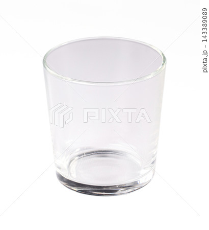 Empty clear drinking glass isolated on white background, transparent tumbler with thick base, studio product shot of simple glassware Empty clear drinking glass isolated on white background, transparent tumbler with thick base, studio product shot of simple glassware 143389089