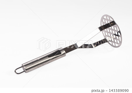 White surface featuring stainless steel potato masher with rubber grip handle culinary utensil White surface featuring stainless steel potato masher with rubber grip handle culinary utensil 143389090