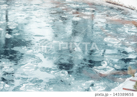 serene river flows through a snowy landscape. The water is clear and reflects the winter scenery, evoking a sense of calm and mindfulness. serene river flows through a snowy landscape. The water is clear and reflects the winter scenery, evoking a sense of calm and mindfulness. 143389658