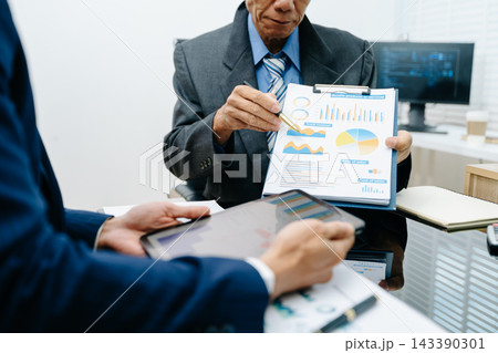Team business meeting presentation. Hand businessman working project in modern office.Laptop computer and tablet and smart phone on desk Team business meeting presentation. Hand businessman working project in modern office.Laptop computer and tablet and smart phone on desk 143390301