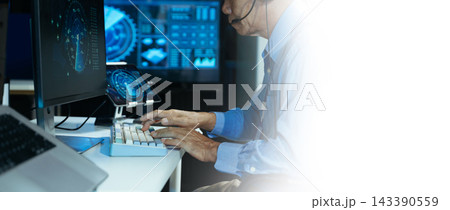 Focused operators with headsets monitor real-time data screens during late-night technical operations Focused operators with headsets monitor real-time data screens during late-night technical operations 143390559