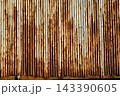 Texture or background of Rusted, aged galvanized sheet metal wall surface; weathered galvanized steel fence; retro concept; the artistry of old, rusty galvanized sheeting; vintage-style metal panels. 143390605