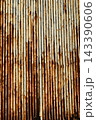Texture or background of Rusted, aged galvanized sheet metal wall surface; weathered galvanized steel fence; retro concept; the artistry of old, rusty galvanized sheeting; vintage-style metal panels. 143390606