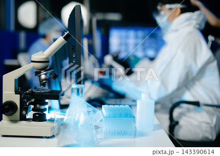 Scientist in protective hazmat suit analyzes DNA data and scientific charts on a modern computer screen in a medical laboratory Scientist in protective hazmat suit analyzes DNA data and scientific charts on a modern computer screen in a medical laboratory 143390614
