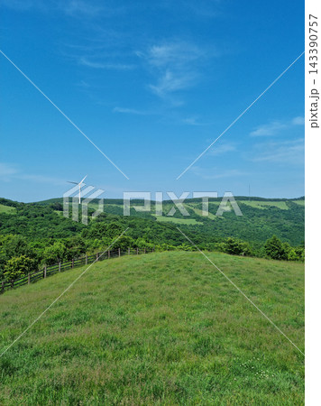 This is a landscape of a meadow with a wind turbine. This is a landscape of a meadow with a wind turbine. 143390757