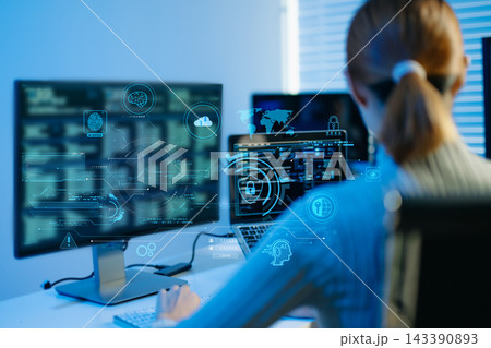 Female programmer working with coding software, laptop and computer screens in a modern technology workspace, representing programming Female programmer working with coding software, laptop and computer screens in a modern technology workspace, representing programming 143390893