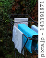 blue jeans hanging on a metal rail 143391871