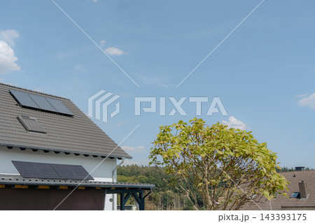 solar panels installed stationary on a residential roof, surrounded by clear skies and greenery, creating a peaceful and eco-friendly environment for sustainable home improvement with blue. solar panels installed stationary on a residential roof, surrounded by clear skies and greenery, creating a peaceful and eco-friendly environment for sustainable home improvement with blue. 143393175