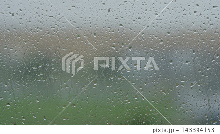 Rain drop hitting window glass and sliding down Rain drop hitting window glass and sliding down 143394153