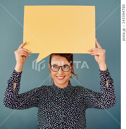 Portrait, space and speech bubble with business woman in studio on blue background for information. Advertising, marketing or mockup and employee with information on poster for news or social media 143394780