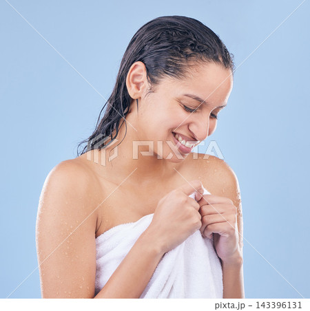 Woman, beauty and wet hair in studio for wellness, skincare or treatment on blue background. Young person or model smile and thinking in towel and shower for hygiene, grooming and moisture or washing Woman, beauty and wet hair in studio for wellness, skincare or treatment on blue background. Young person or model smile and thinking in towel and shower for hygiene, grooming and moisture or washing 143396131