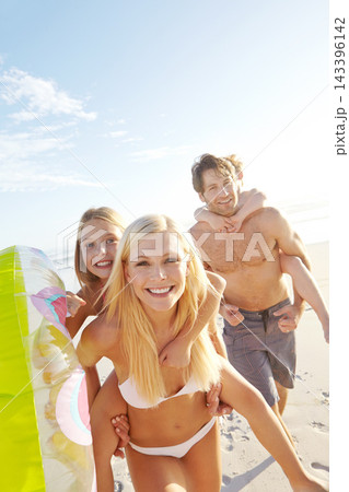 Portrait, beach and happy family piggyback kids on holiday together for summer vacation, travel or play with inflatable. Mother, father and carry children at sea for adventure, support or connection 143396142