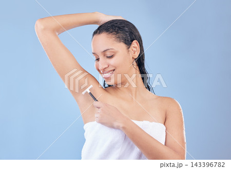 Happy, woman and razor for shaving armpit, grooming and cleaning with skincare routine and towel in studio. Smile, female person or model for hair removal, hygiene and wellness on blue background Happy, woman and razor for shaving armpit, grooming and cleaning with skincare routine and towel in studio. Smile, female person or model for hair removal, hygiene and wellness on blue background 143396782