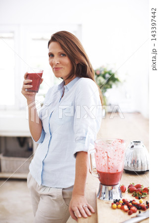Woman, portrait and drink in kitchen for smoothie or shake, handmade and fresh recipe for breakfast detox diet. Girl, strawberry and ideas for meal alternative, vitamin boost and natural nutrition. Woman, portrait and drink in kitchen for smoothie or shake, handmade and fresh recipe for breakfast detox diet. Girl, strawberry and ideas for meal alternative, vitamin boost and natural nutrition. 143397442