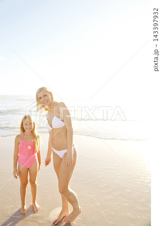 Portrait, mother and happy kid at beach on holiday together for summer vacation, travel or mockup space. Smile, mom and girl child at ocean in swimsuit for adventure, care or family bonding by water Portrait, mother and happy kid at beach on holiday together for summer vacation, travel or mockup space. Smile, mom and girl child at ocean in swimsuit for adventure, care or family bonding by water 143397932