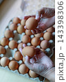 Hand Selecting Fresh Chicken Eggs from Egg Cartons 143398306