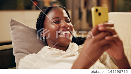 Happy, typing and black woman with phone on sofa for online chat, communication and networking. Relax, home and person on smartphone for social media, funny website and internet news in living room Happy, typing and black woman with phone on sofa for online chat, communication and networking. Relax, home and person on smartphone for social media, funny website and internet news in living room 143398756