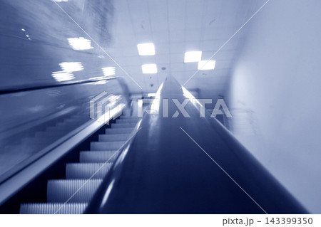 Escalator Motion Blur in Modern Blue Urban Interior Escalator Motion Blur in Modern Blue Urban Interior 143399350
