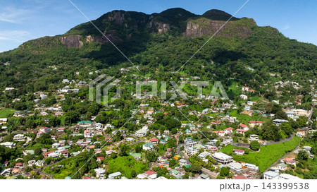 Aerial view of town surrounded by green hills under a clear blue sky. Victoria. Seychelles, Mahe. 143399538