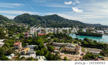 Harbor view with boats and cityscape nestled against green hills. Victoria. Seychelles, Mahe. Harbor view with boats and cityscape nestled against green hills. Victoria. Seychelles, Mahe. 143399563
