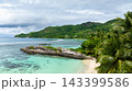 Rocky outcrop surrounded by turquoise waters and beach. Anse Forbans. Seychelles, Mahe. 143399586