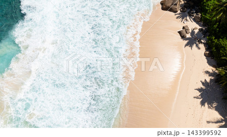 Waves crashing on the sandy coastline with palm shadows on the shore. Seychelles, Mahe. Waves crashing on the sandy coastline with palm shadows on the shore. Seychelles, Mahe. 143399592