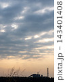 Factories and tall smokestacks stand alone amidst agricultural and wasteland areas 143401408
