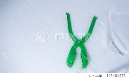 Green Plastic Snowball Maker Toy Lying on White Snow Top View Green Plastic Snowball Maker Toy Lying on White Snow Top View 143401473