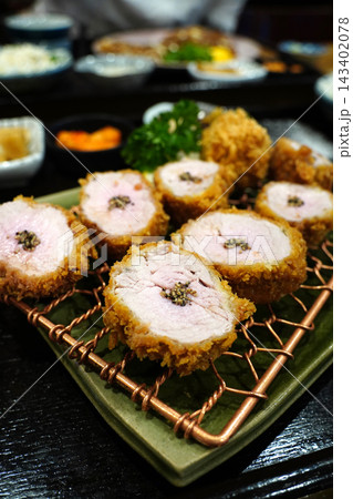 Juicy and tender pork tenderloin cutlet, hirekatsu, served on a wire rack 143402078
